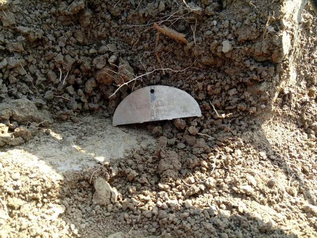 This half dog tag was found on a medical pit